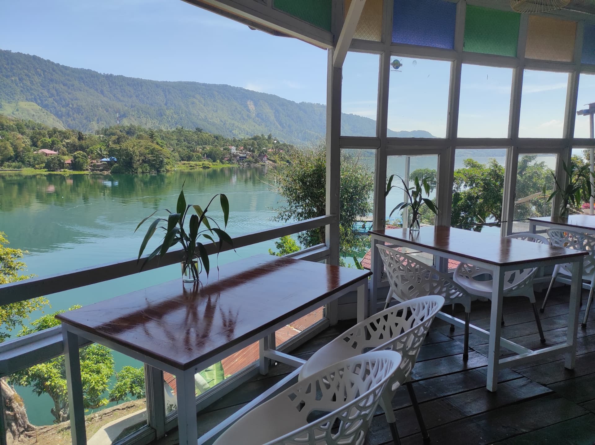 Café tables looking out over the calm water of Lake Toba