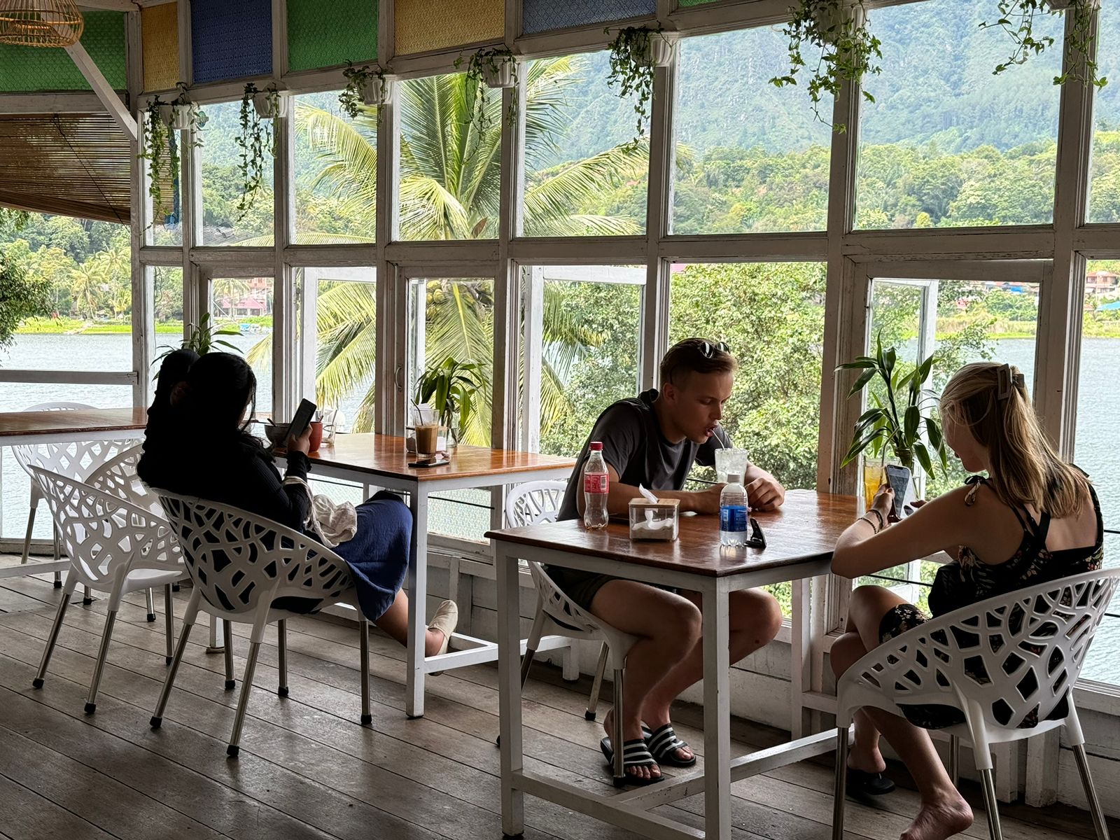 Guests relaxing with drinks at the window tables