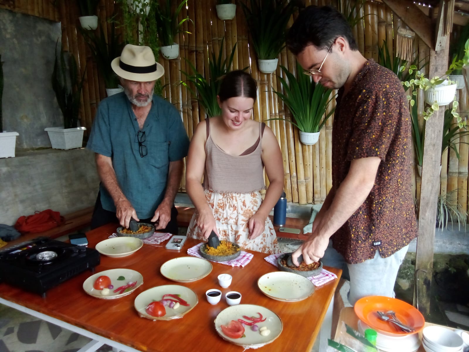 Guests preparing three different sambals with fresh chilies and spices